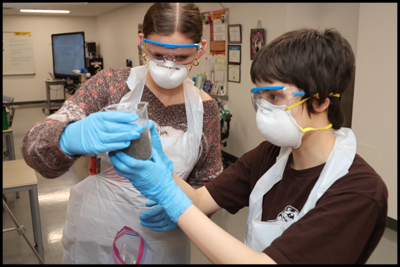 science students looking at a beaker