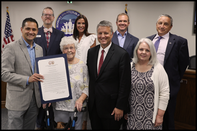 Del. Sam Rasoul presents a General Assembly proclamation to Dr. Nicely and family